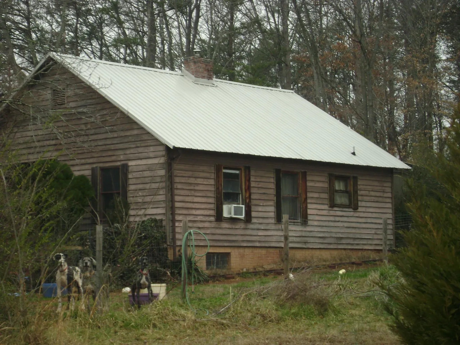 White metal roof on an old wood sided farmhouse, from a Metal Roof Installation job in Fallentimber